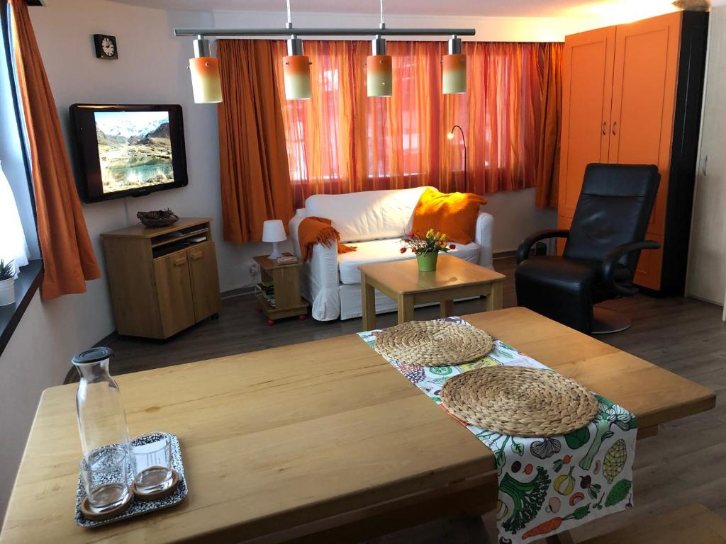 a living room with a table and a couch at Cresta di Saas in Saas-Grund