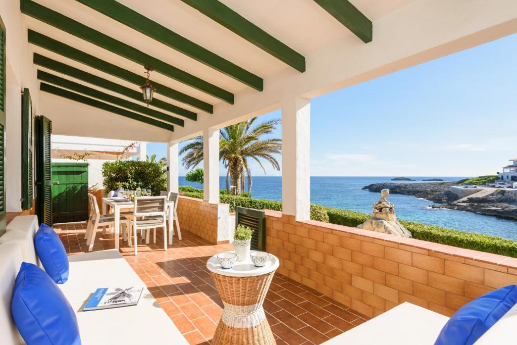 a patio with a view of the ocean at Brisa Marina in Sant Lluis