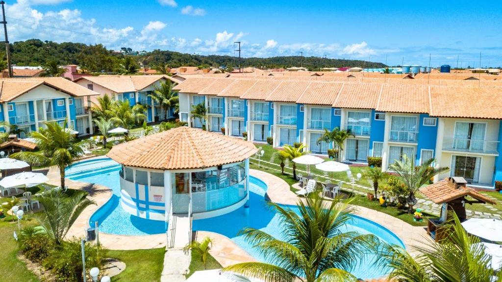 an aerial view of a resort with a swimming pool at Apartamento Mont Sião II in Porto Seguro