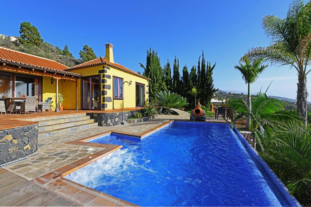 a swimming pool in front of a house at Villa Lomo Gonzalez in Tijarafe