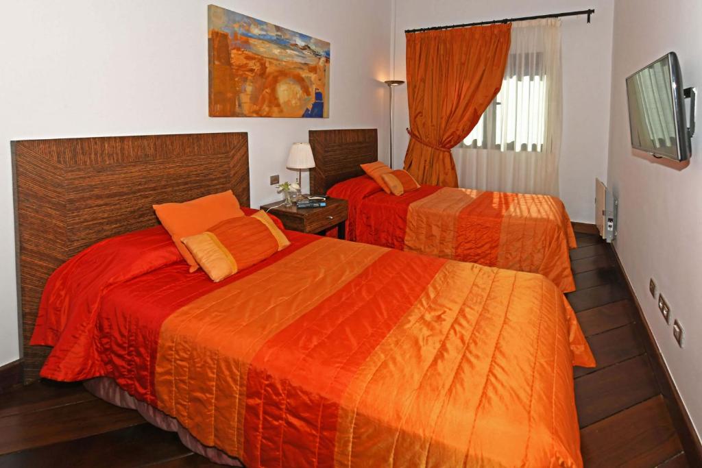 A bed or beds in a room at Salobre Imperial La Canela