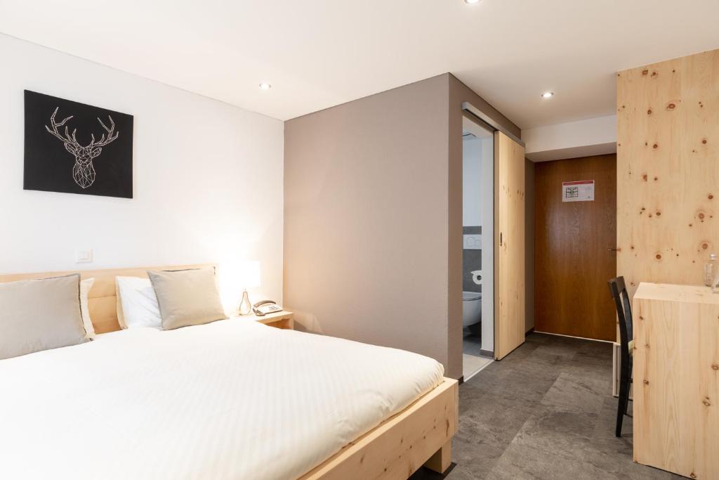 Postel nebo postele na pokoji v ubytování Hotel Bellevue