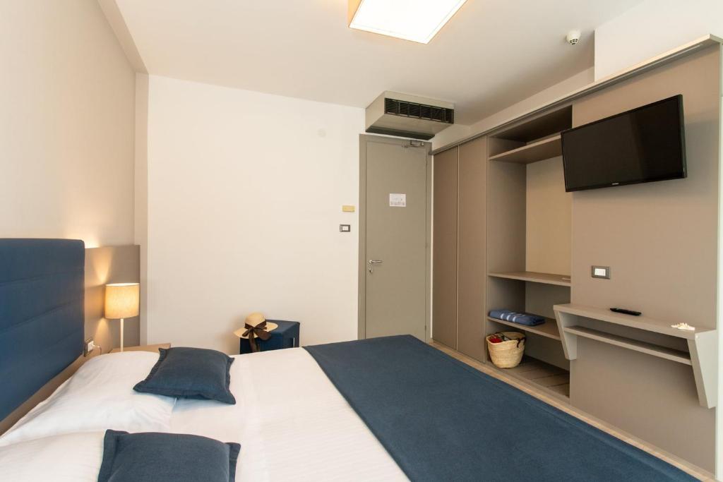 Postel nebo postele na pokoji v ubytování Hotel Delle Mimose