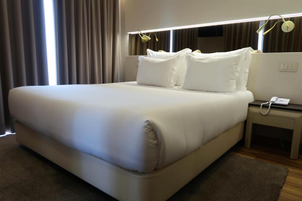 Кровать или кровати в номере Hotel Cristal Setúbal