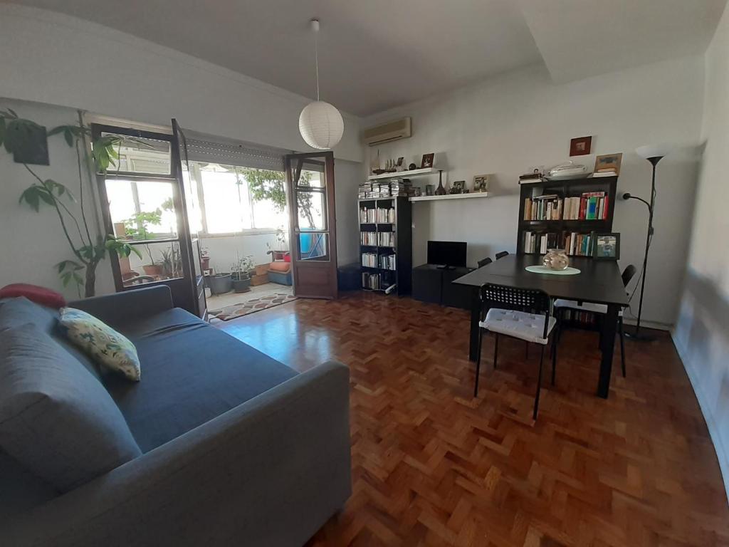 a living room with a couch and a table at Colombo & Stadium Cozy Flat in Lisbon