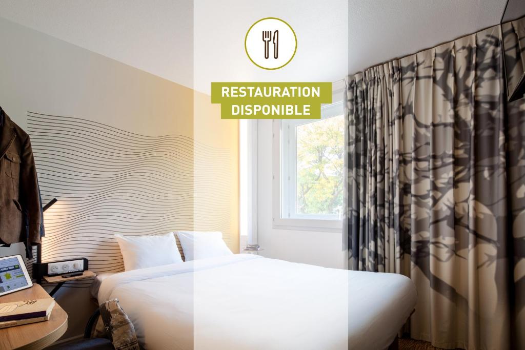 B&B HOTEL Thionville Centre Gare tesisinde bir odada yatak veya yataklar