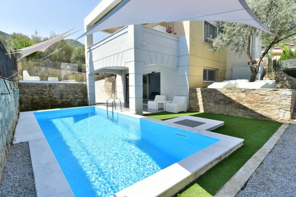 a swimming pool in the backyard of a villa at Alpha Delta Pool Suite in Paleo Tsifliki