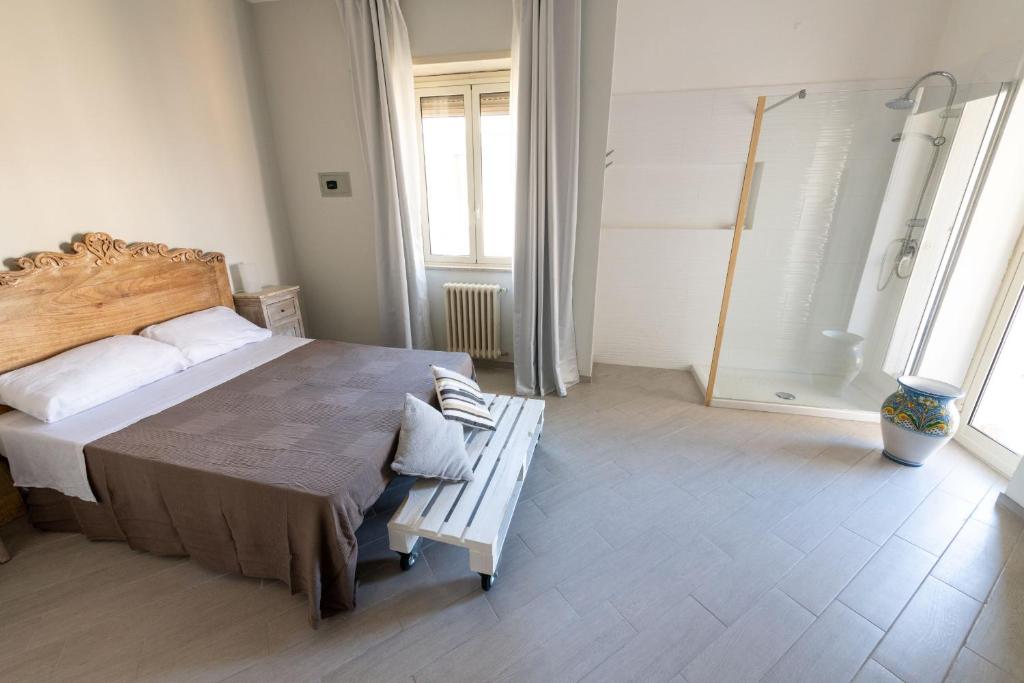 Postel nebo postele na pokoji v ubytování " DOMUS CORALLA" BnB Racconti Di Viaggio