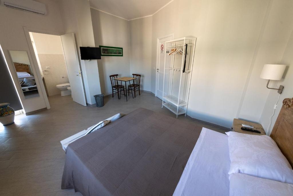 Postel nebo postele na pokoji v ubytování " DOMUS CORALLA" BnB Racconti Di Viaggio
