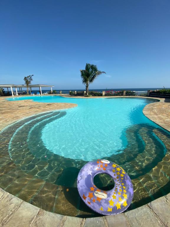 a donut in the water in a swimming pool at Romantic Beach House Vipingo in Vipingo