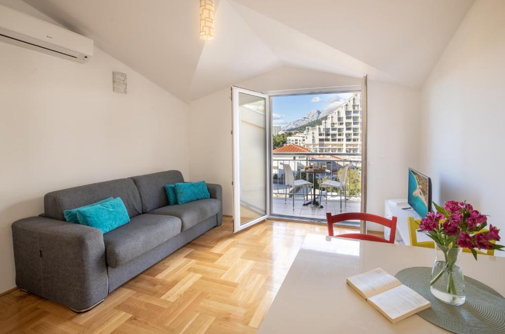 a living room with a couch and a table at Beach Spot Apartments in Makarska