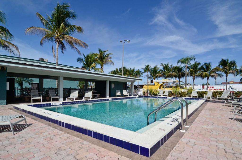 una piscina con sillas y un complejo en Americas Best Value Inn Fort Myers, en Fort Myers