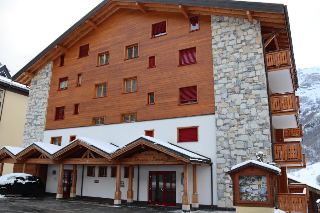 a large building with snow on the roof at Residenz Darianne 12 in Leukerbad