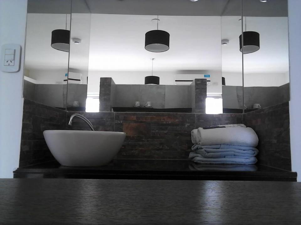 a bathroom with a sink and a counter with towels at NEFERET Habitaciones Temporarias in Corrientes