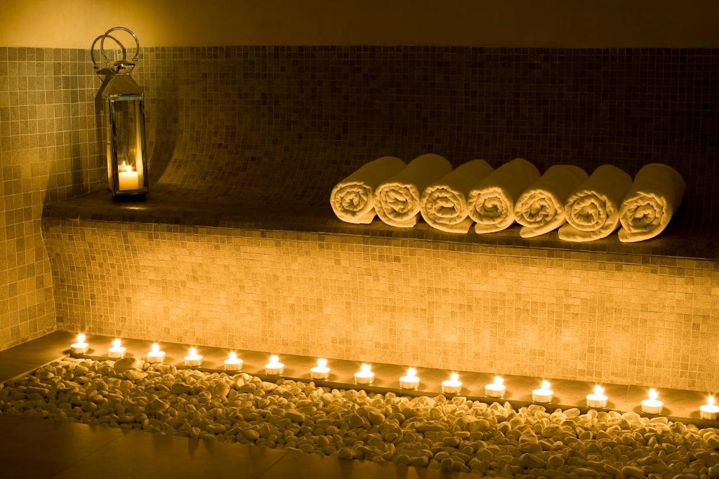 a row of candles on a shelf with lights at Villa Oniria in Granada