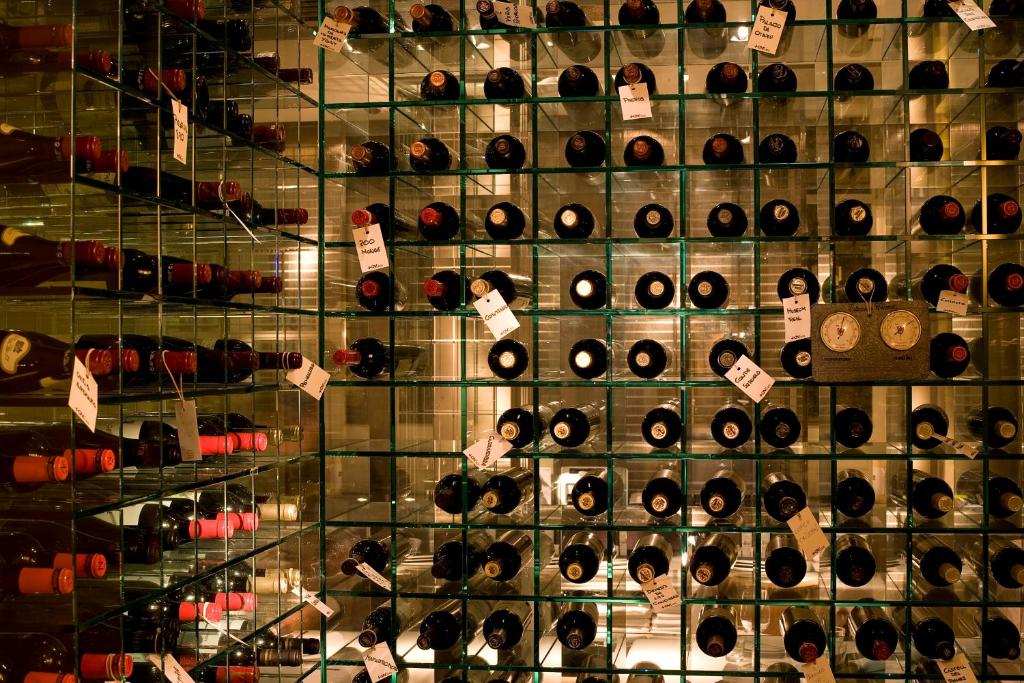 a display case filled with lots of wine bottles at Villa Oniria in Granada
