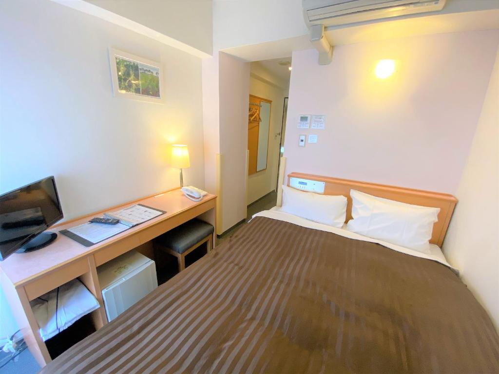 Postel nebo postele na pokoji v ubytování Sakura Hotel Hatagaya