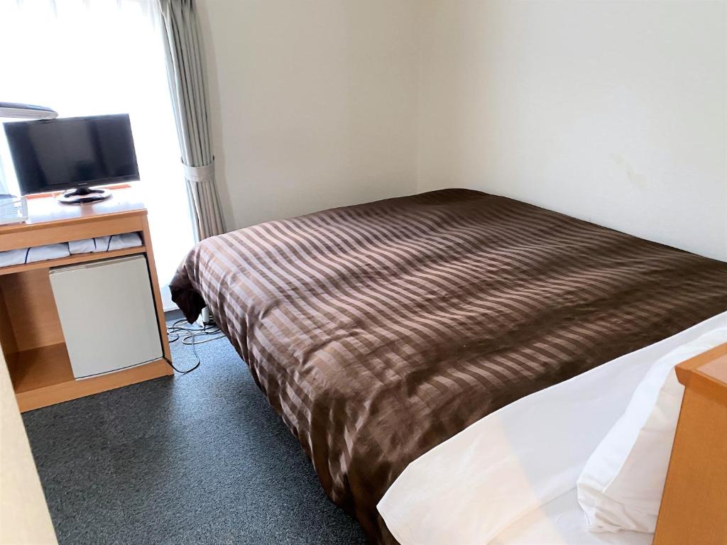 Postel nebo postele na pokoji v ubytování Sakura Hotel Hatagaya