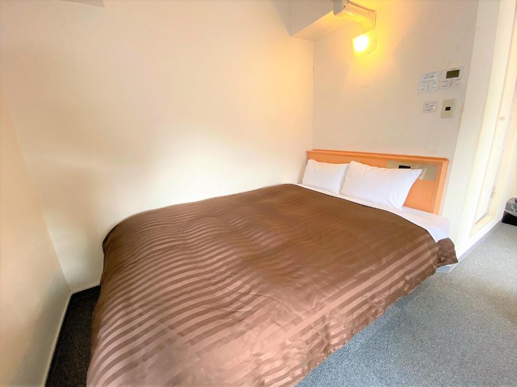 Postel nebo postele na pokoji v ubytování Sakura Hotel Hatagaya