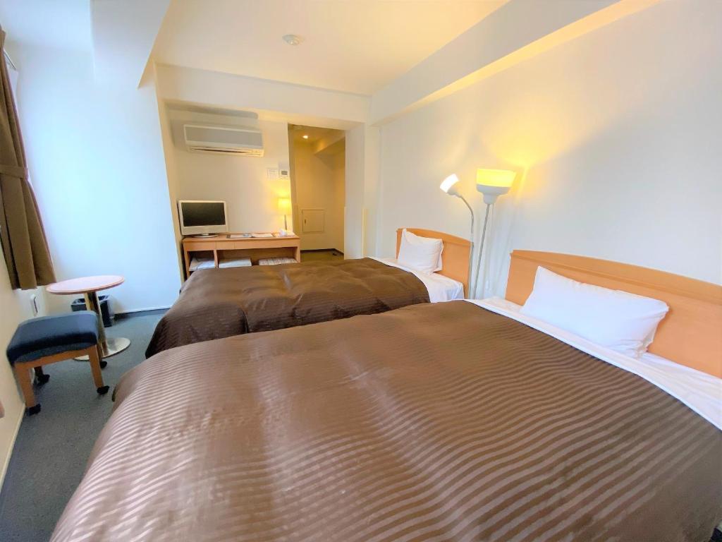 Postel nebo postele na pokoji v ubytování Sakura Hotel Hatagaya