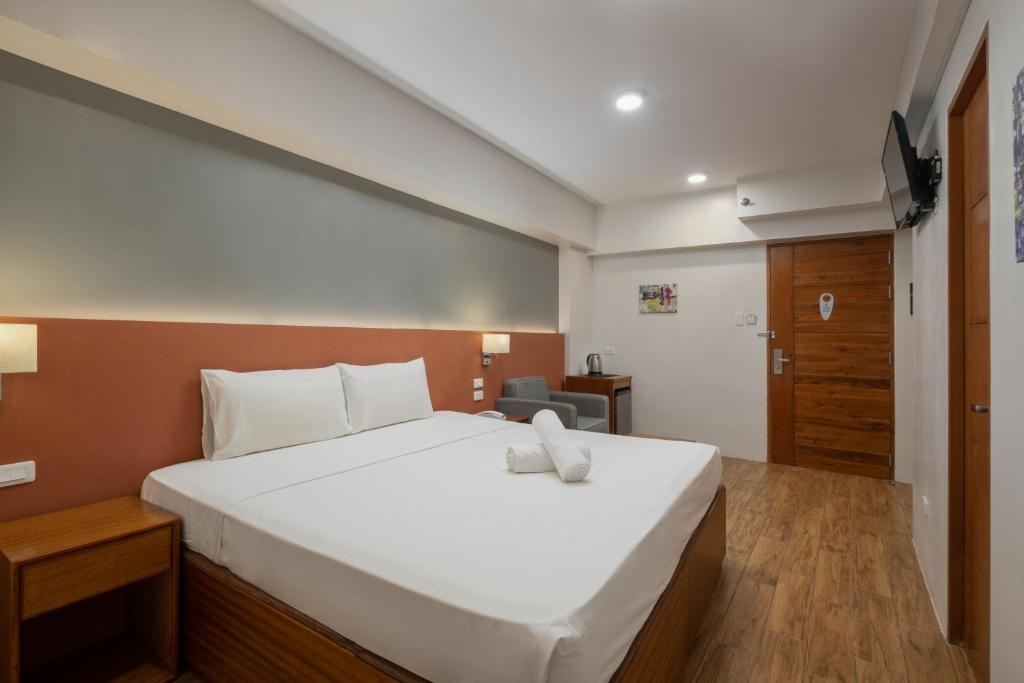 Postel nebo postele na pokoji v ubytování iHotel Uptown BGC