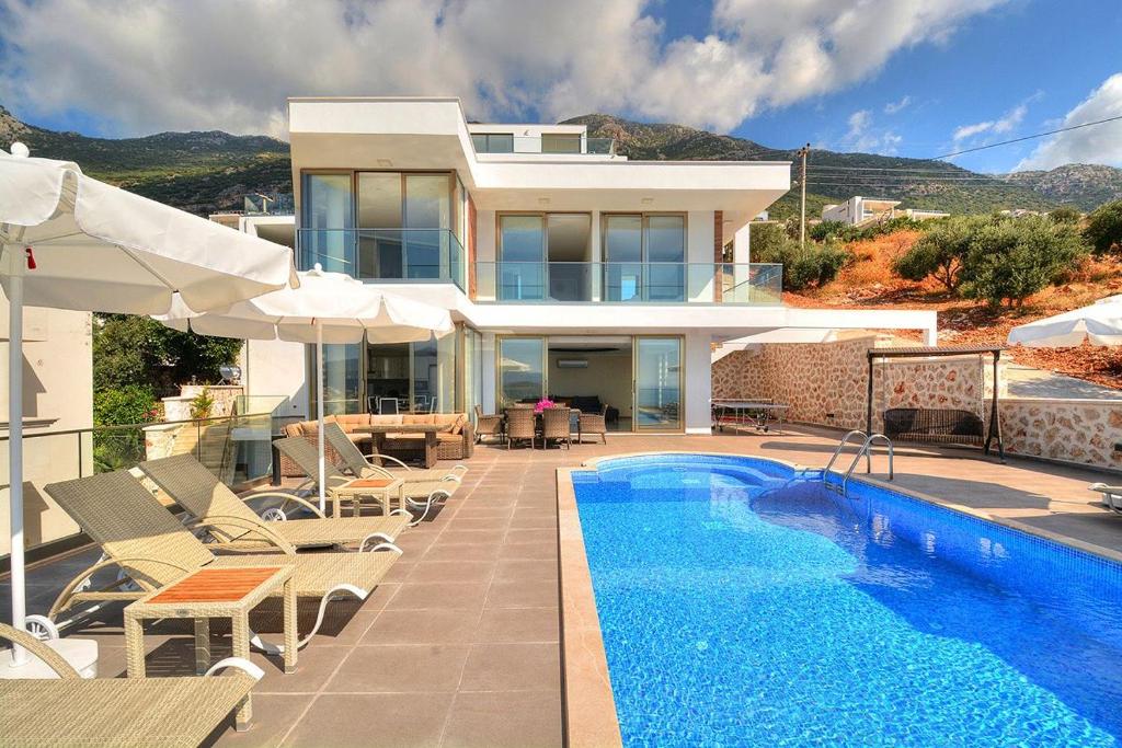 a villa with a swimming pool and a house at Villa Ahiska in Kalkan