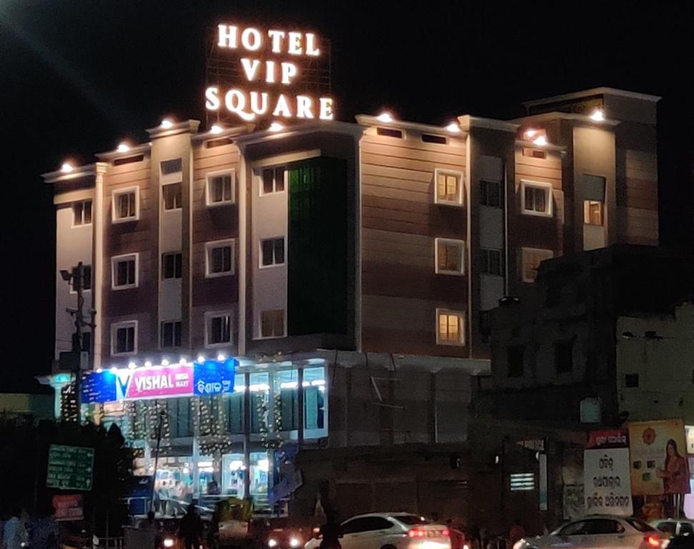 a building with a hotel vip square sign at night at Hotel Vip Square in Puri