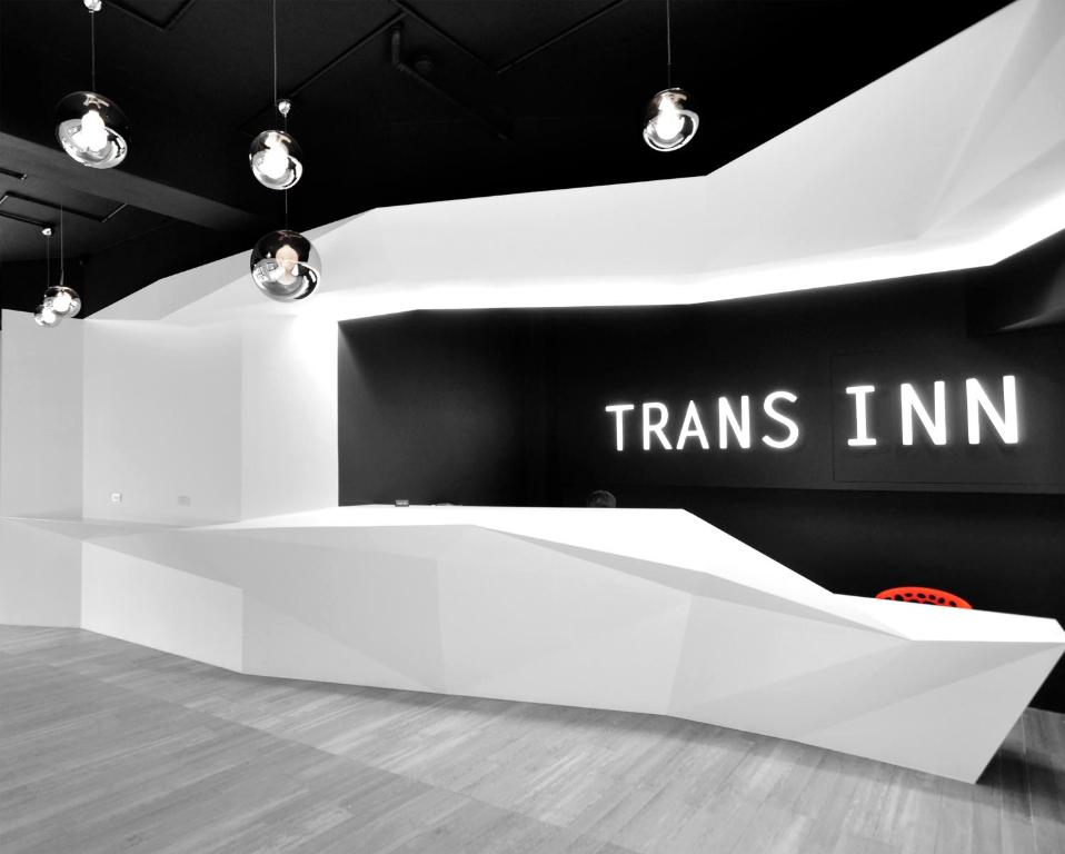 a white exhibit with the words trams inn on a wall at Trans Inn in Taichung