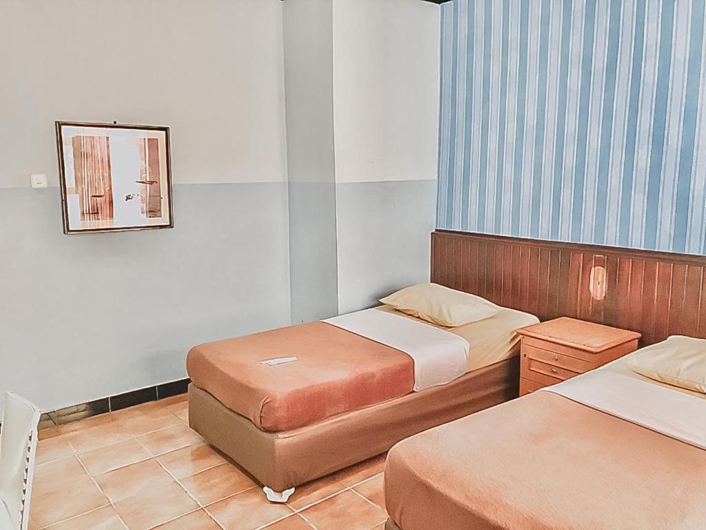 Postel nebo postele na pokoji v ubytování Hotel Aida Syariah Mitra RedDoorz