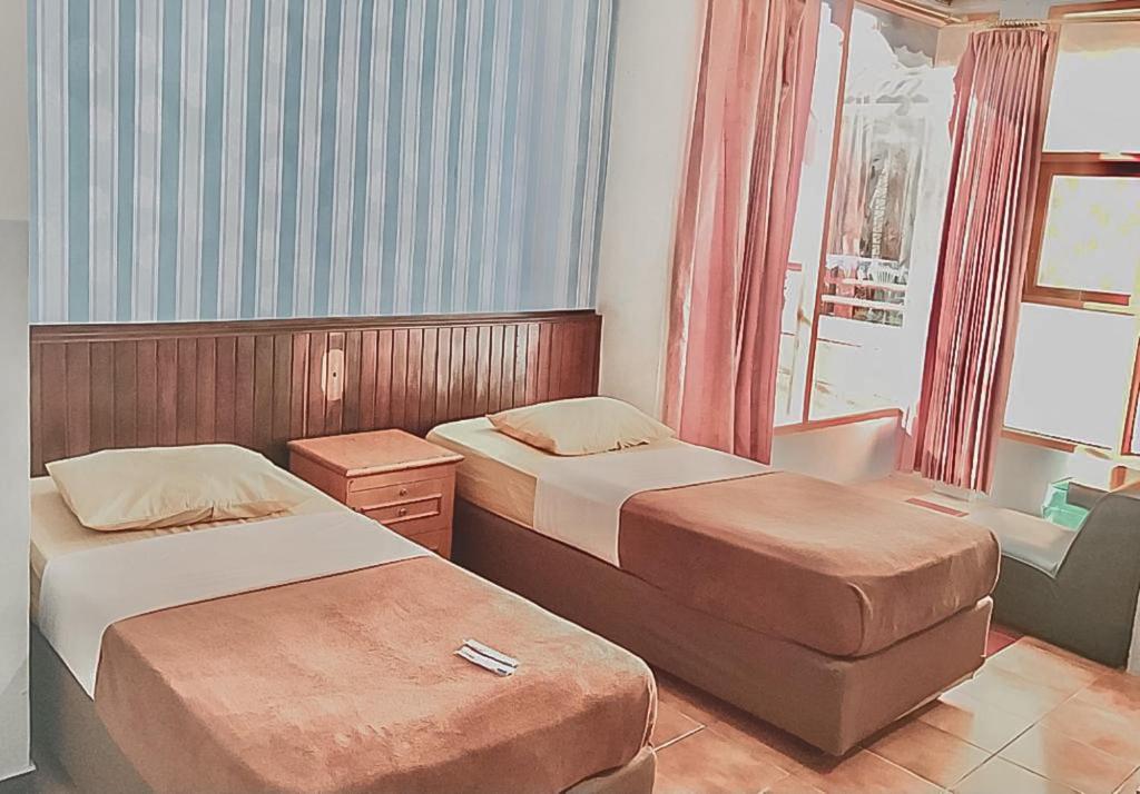 Postel nebo postele na pokoji v ubytování Hotel Aida Syariah Mitra RedDoorz
