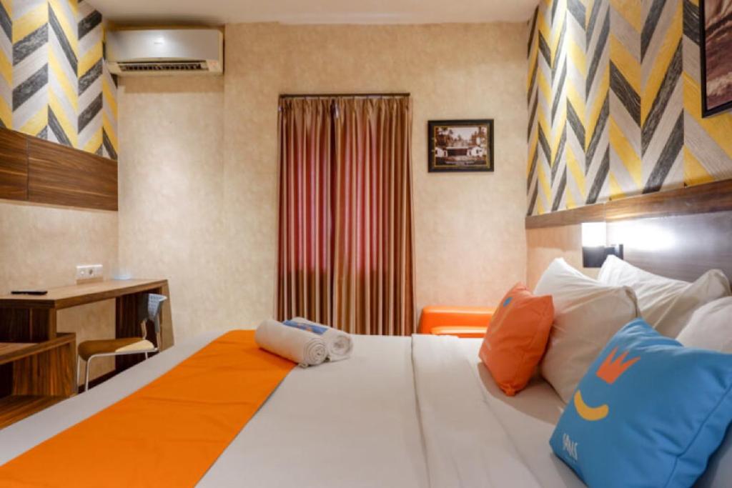 Postel nebo postele na pokoji v ubytování Sans Hotel Ekkon Yogyakarta by Reddoorz