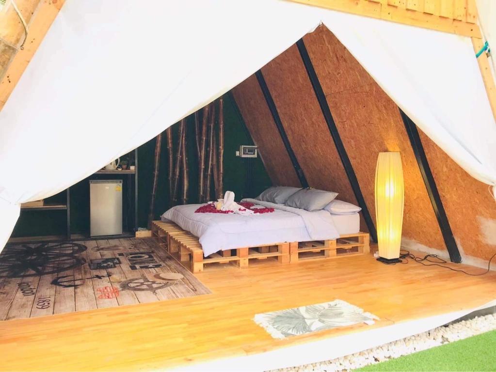 a bedroom with a bed in a tent at Bridge Hill Cafe Glamping in Khao Sok