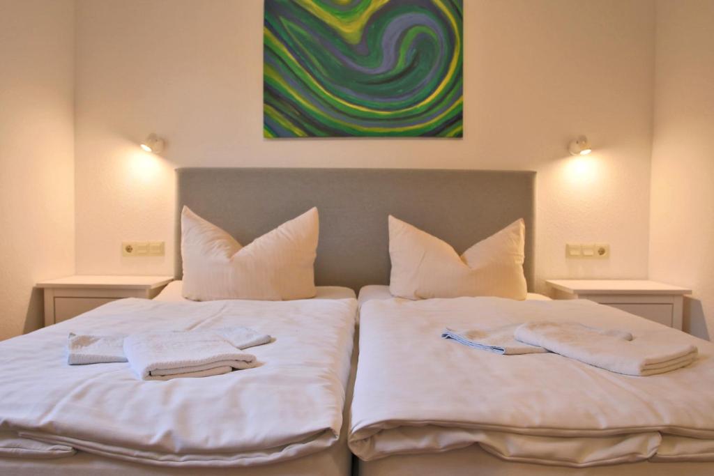 Postel nebo postele na pokoji v ubytování Hotel & Restaurant Am Wasser