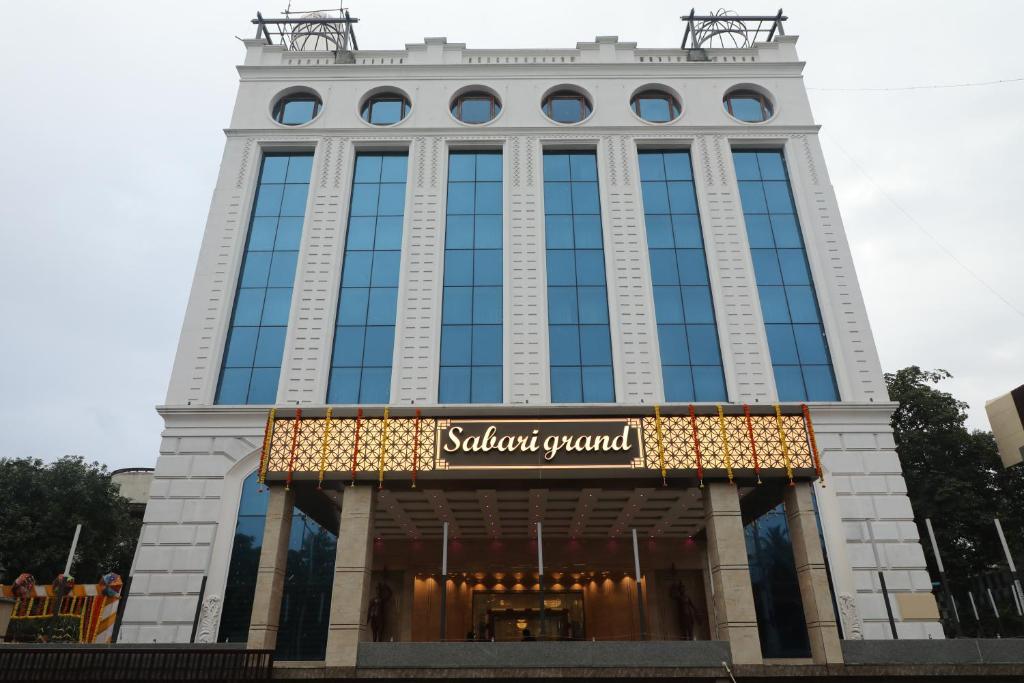 a tall building with a sign in front of it at Quality Inn Sabari in Chennai