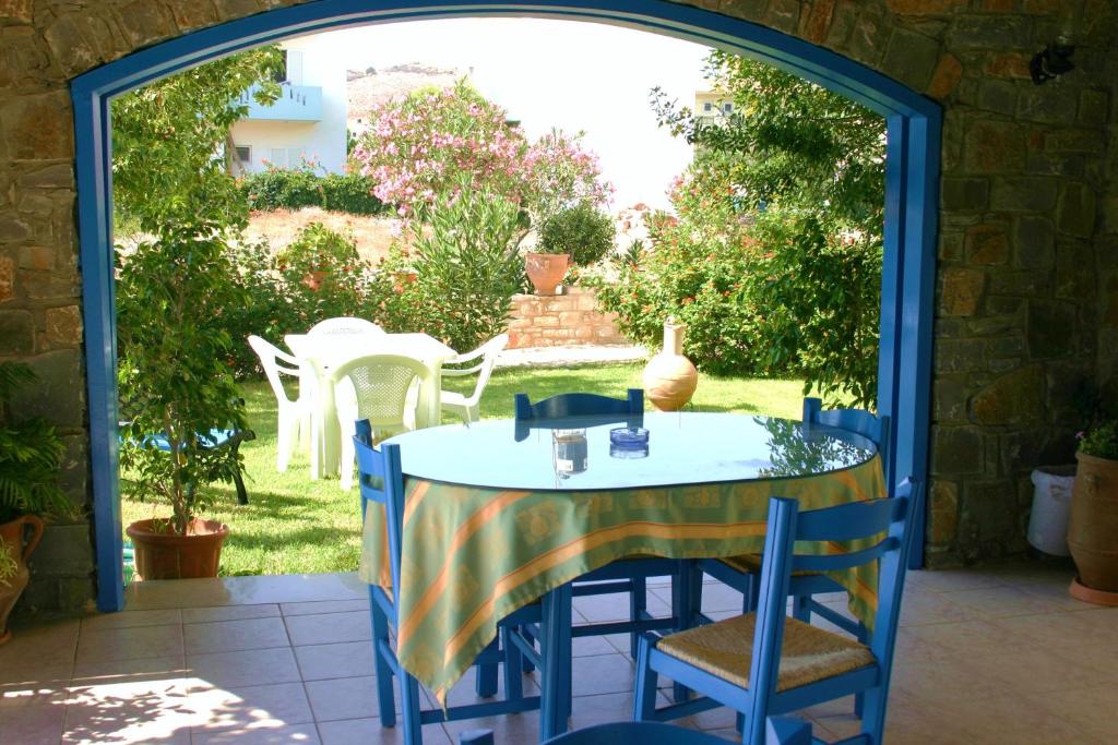 a blue table and chairs on a patio at Hotel Aglaia in Kalamaki