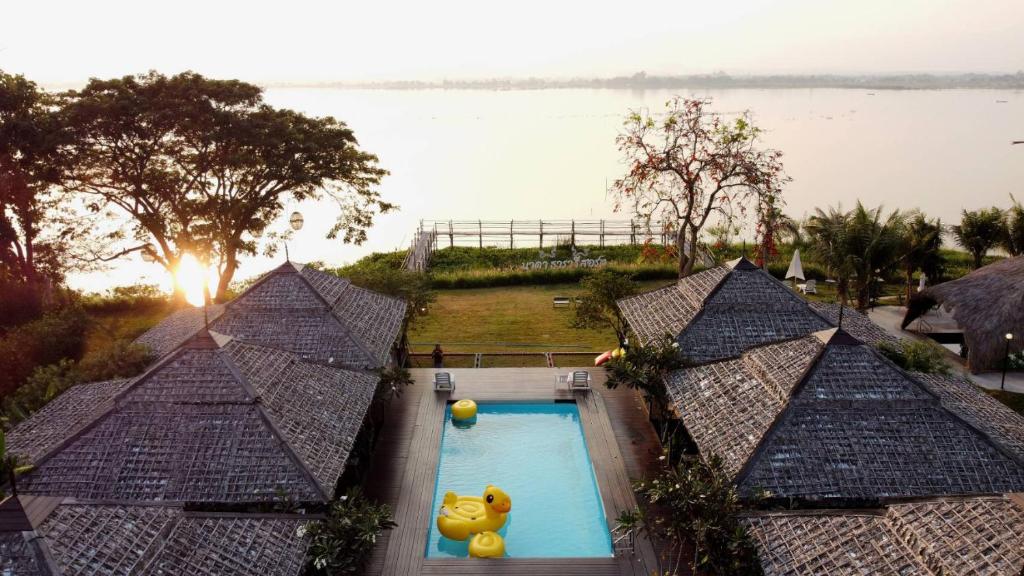 an overhead view of a swimming pool with a bear in it at Naga Tara Boutique Resort in Phayao