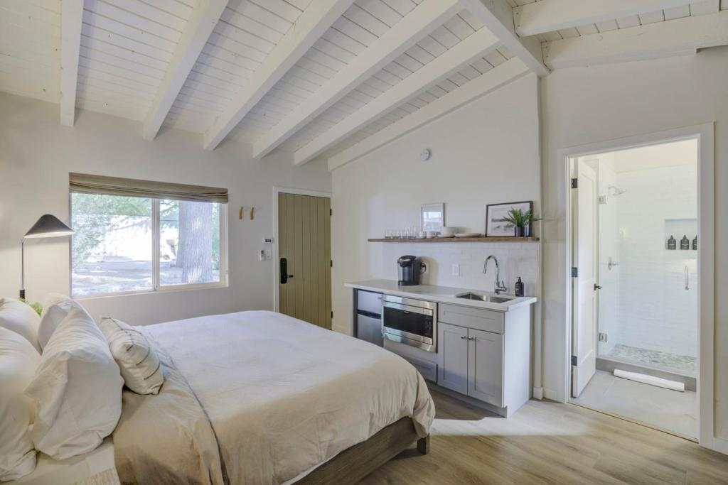 a white bedroom with a large bed and a sink at South Lake Chalet-Boutique Suite-Minutes to Heavenly & Lake Tahoe in South Lake Tahoe