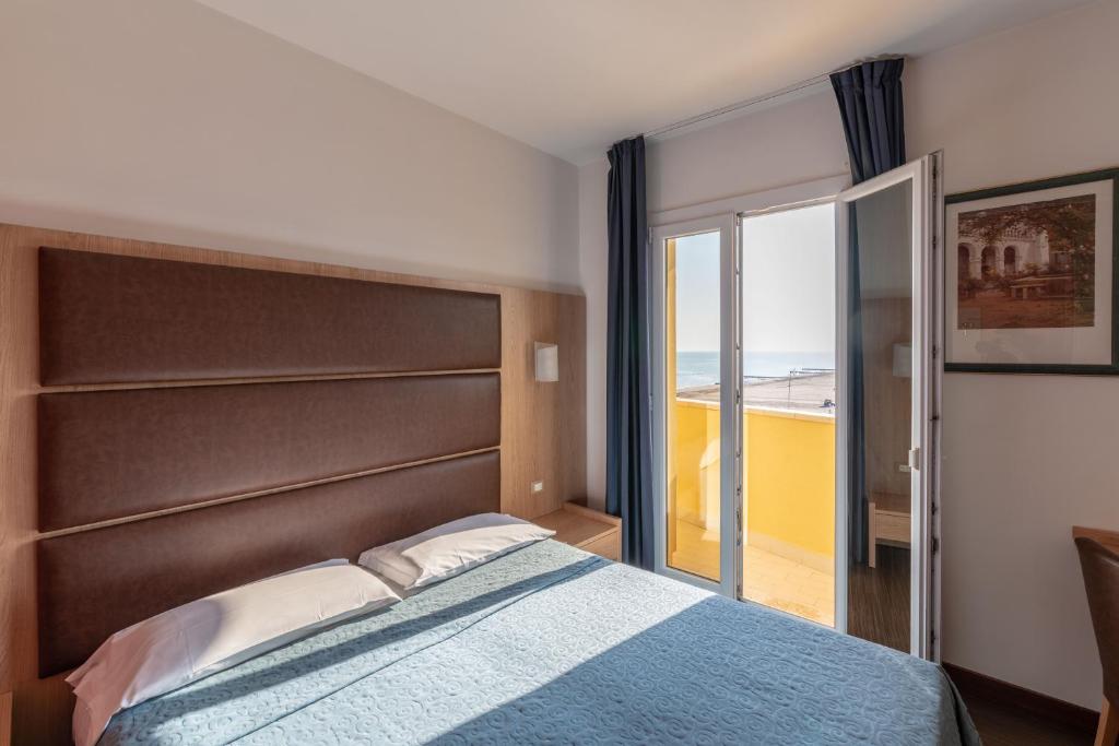 Postel nebo postele na pokoji v ubytování Hotel Mondial