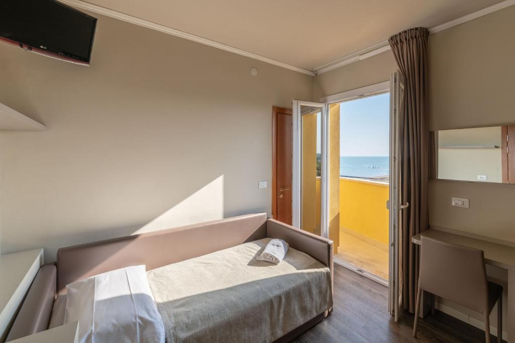 Postel nebo postele na pokoji v ubytování Hotel Mondial