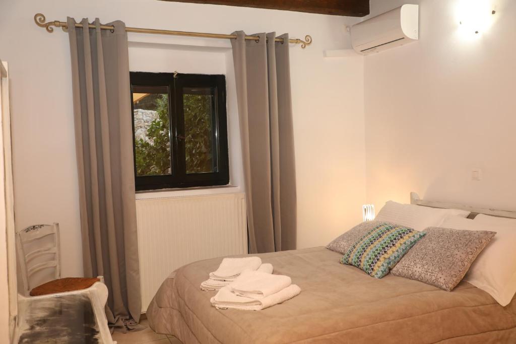 a bedroom with a bed with towels on it at Xigia Escape villas in Khartáta