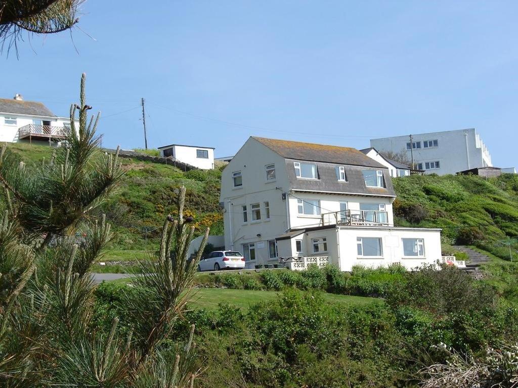 a house on the side of a hill at White Ocean in Mawgan Porth