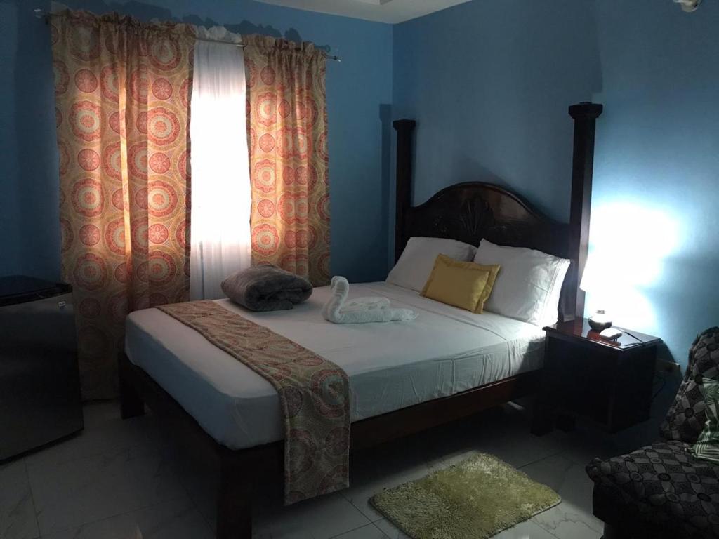 a bedroom with a bed and a window at Raine’s studio and more in Kingston