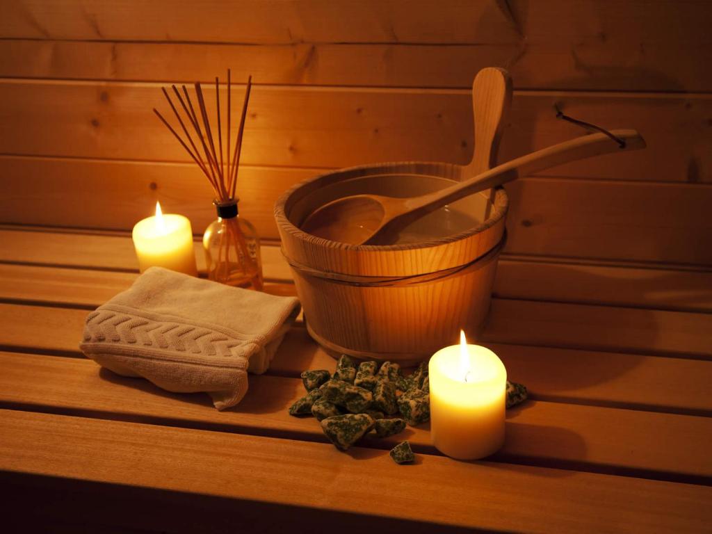 a group of candles and a bath tub with a bowl and a wooden spoon at Cerro Mar Atlantico & Cerro Mar Garden in Albufeira