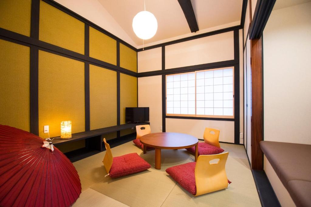 a living room with a table and chairs at Guest House Kyoto Mills Benitoan - Vacation STAY 19493v in Kyoto