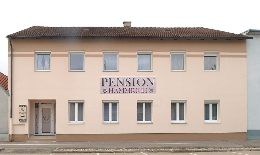 a building with a sign on the side of it at Pension Hammrich in Neudörfl