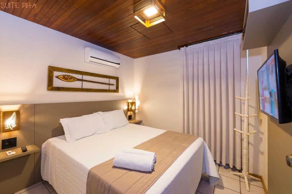 Cama ou camas em um quarto em Pousada Kia Ora Bombinhas