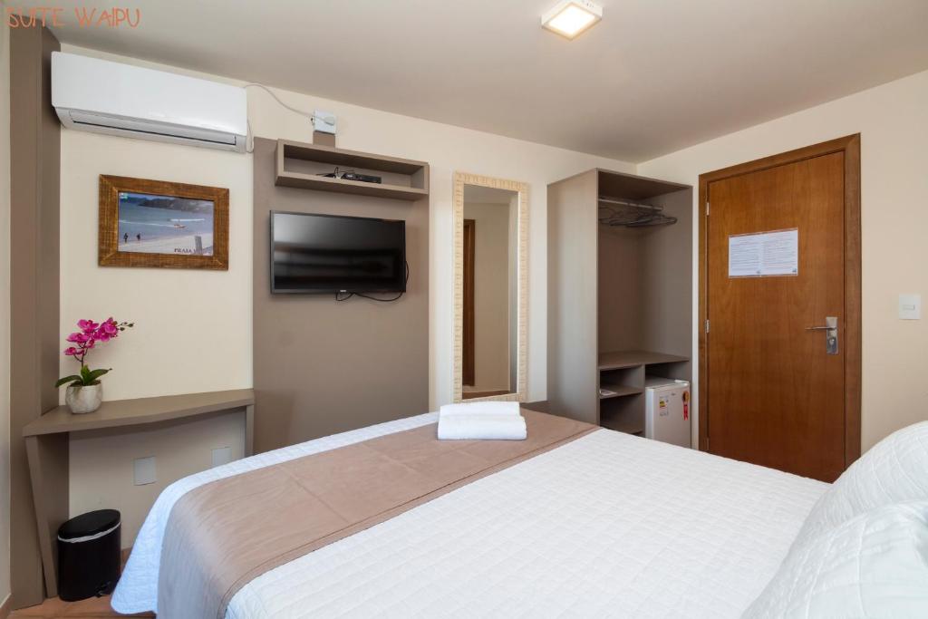Cama ou camas em um quarto em Pousada Kia Ora Bombinhas