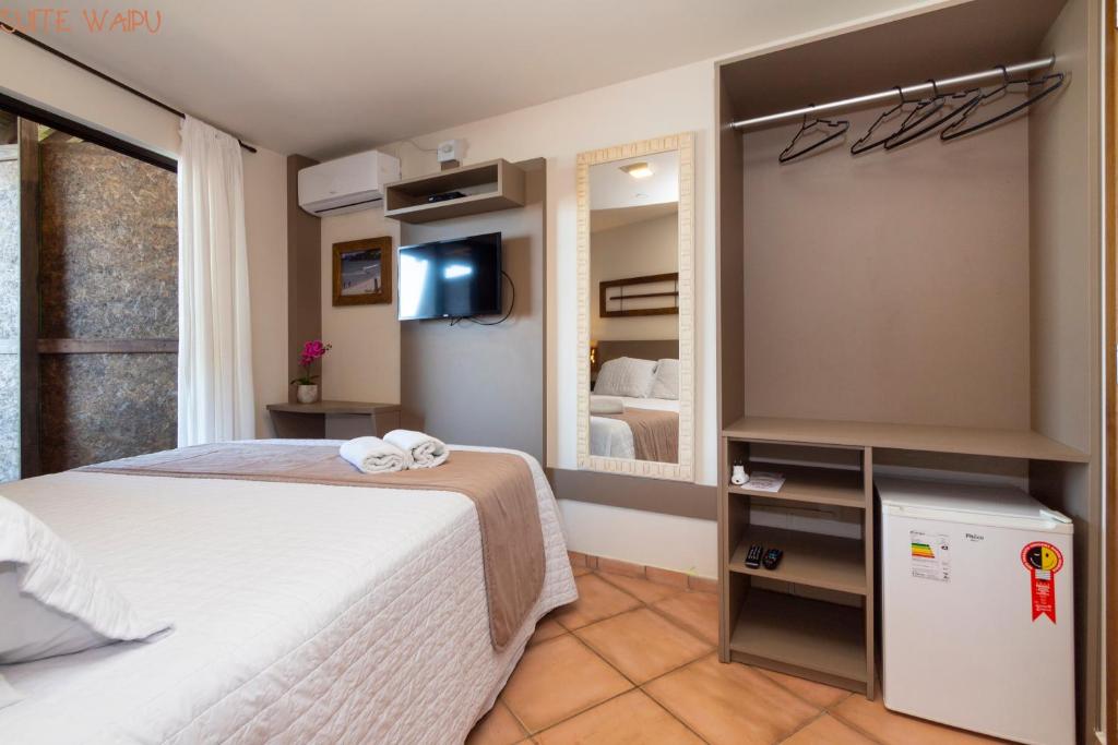 Cama ou camas em um quarto em Pousada Kia Ora Bombinhas