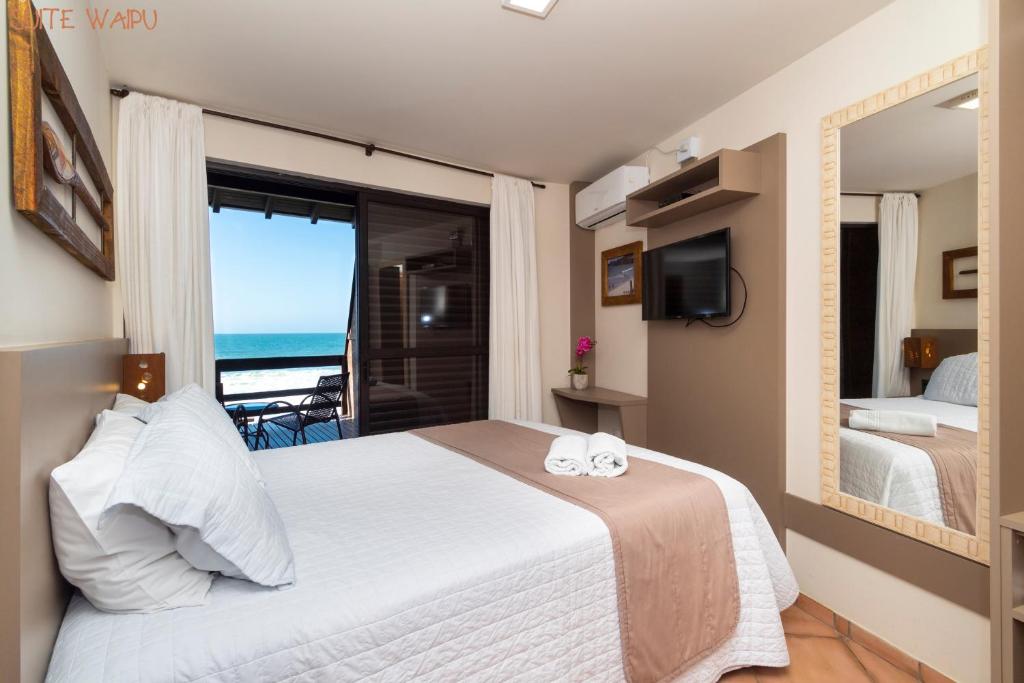 Cama ou camas em um quarto em Pousada Kia Ora Bombinhas