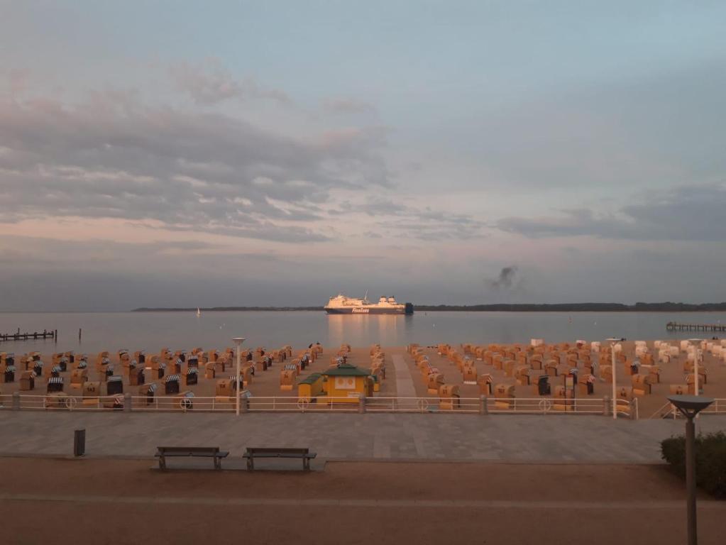 a group of chairs sitting on the water at Nock by WellenRausch in Travemünde